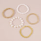 Kit pulseras doradas y de perlas