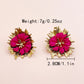 Aretes retro flor fucsia