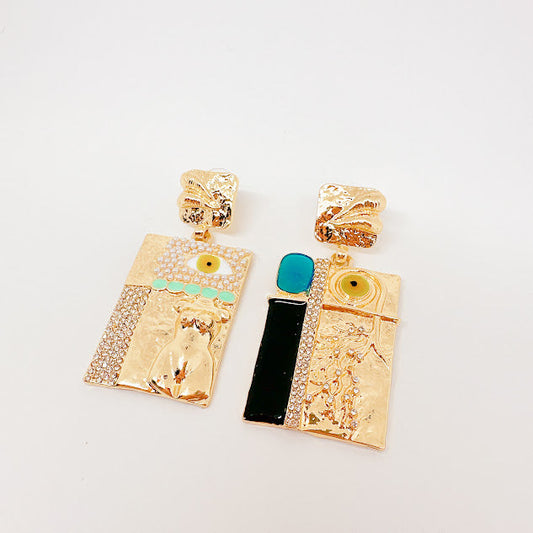 Aretes Anatomy Torso y ojos dorados