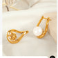 Aretes elegantes con perla en forma de gota