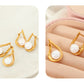 Aretes elegantes con perla en forma de gota
