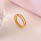 Anillo doble con circonias trenzado dorado