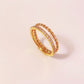 Anillo doble con circonias trenzado dorado