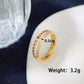 Anillo doble con circonias trenzado dorado