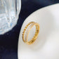 Anillo doble con circonias trenzado dorado