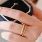 Anillo doble con circonias trenzado dorado